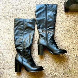 Black leather zip up knee high women’s boots.